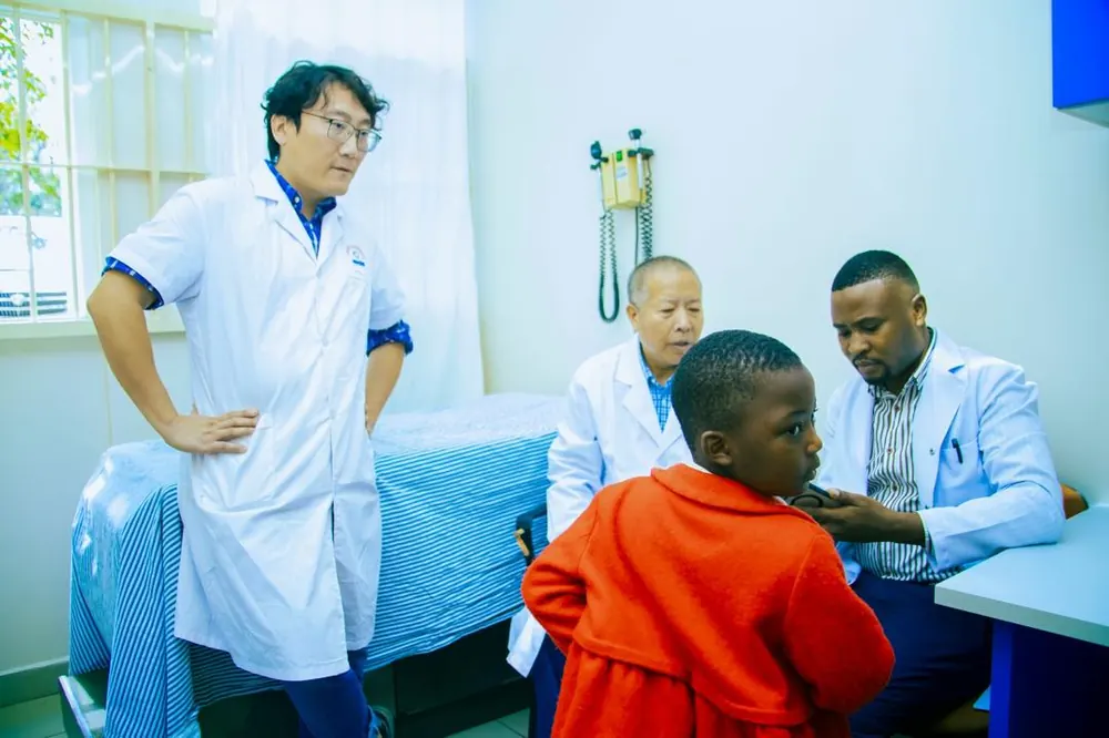 Doctors examining a young patient at the Arusha Specialist Medical Camp